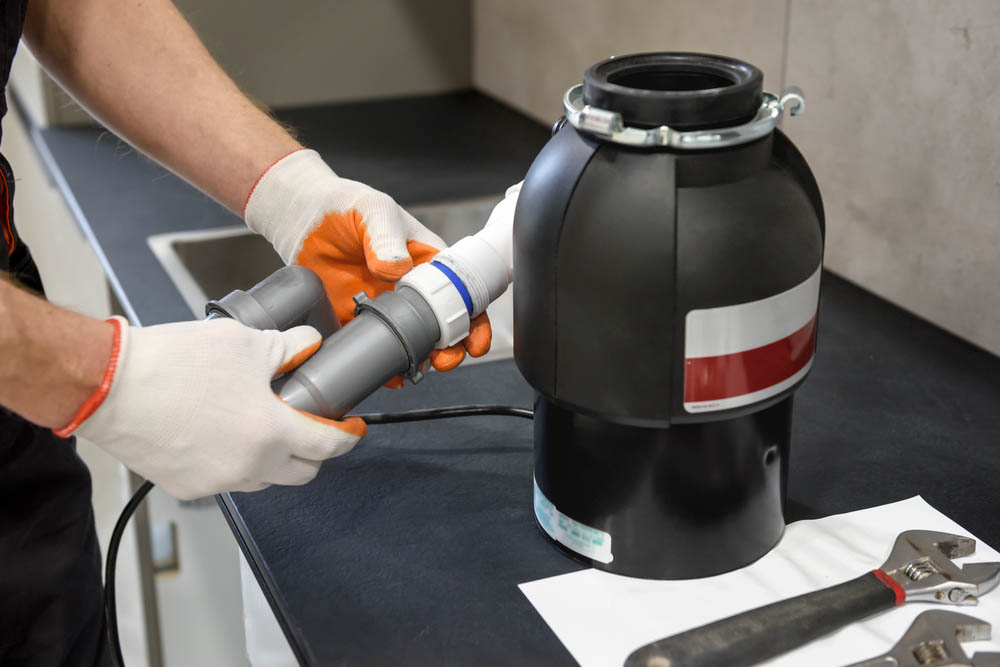 plumber installing a new garbage disposal Cuyahoga Falls, OH