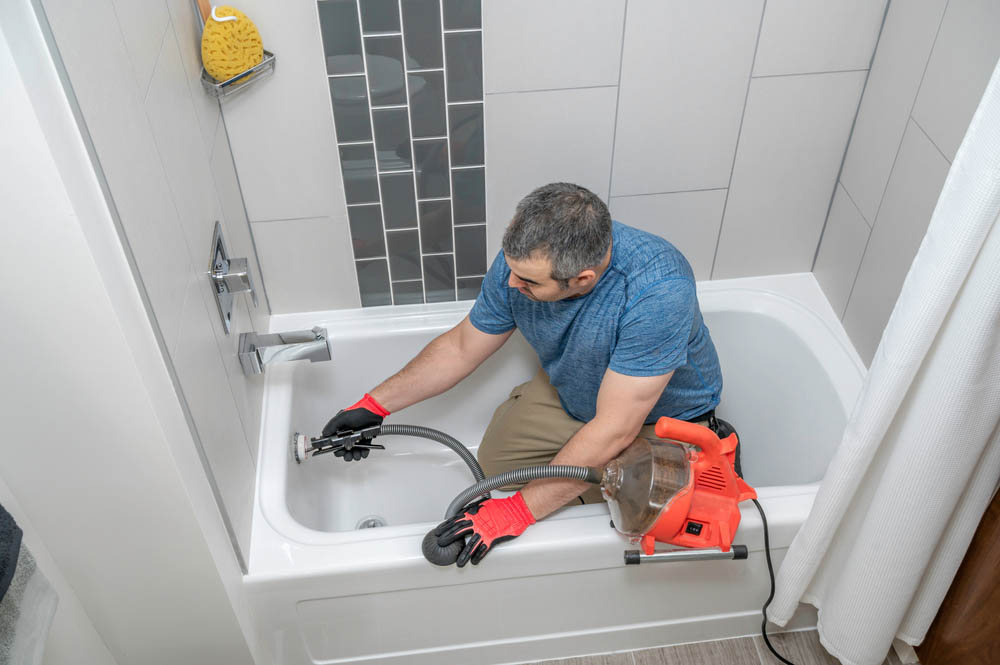 drain or sewer snaking performed by a plumber drain or sewer snaking performed by a plumber