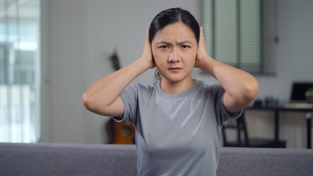 homeowner covering their ears