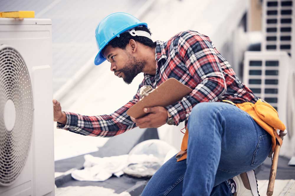 technician inspecting an HVAC unit