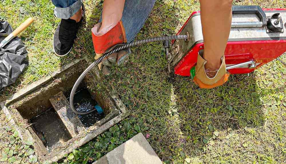 plumbing technician cleaning drain/sewer line Cuyahoga Falls, OH
