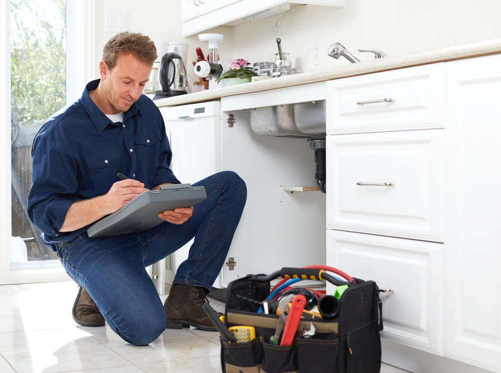 technician inspecting a drain