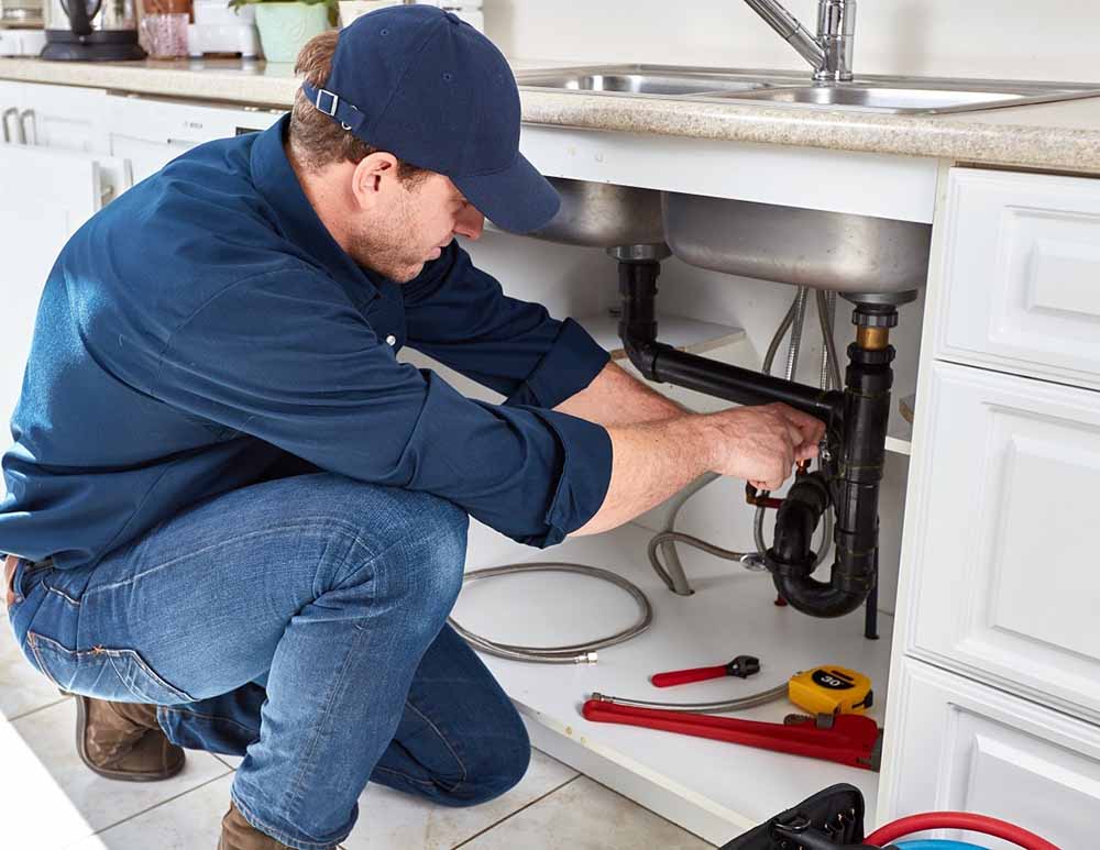 C. Lee technician unclogging a residential drain
