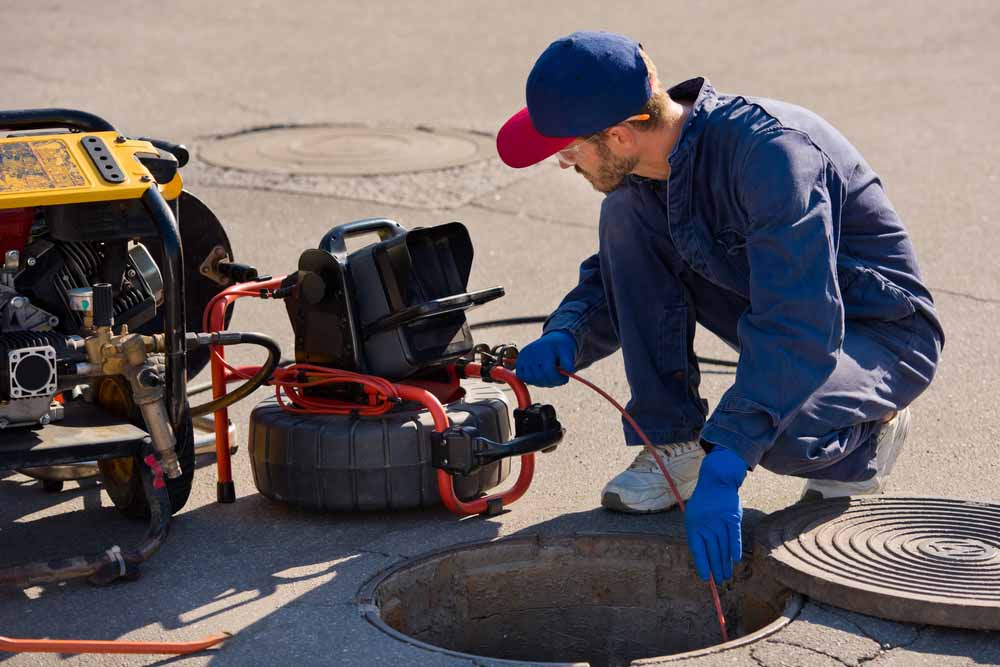 technician preparing sewer camera equipment