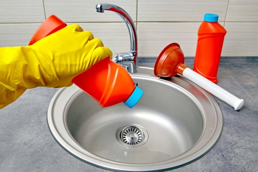 a person pouring chemical drain cleaners down the sink Stow, OH