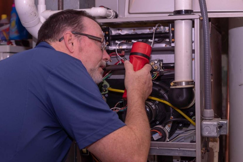 HVAC technician inspecting a furnace