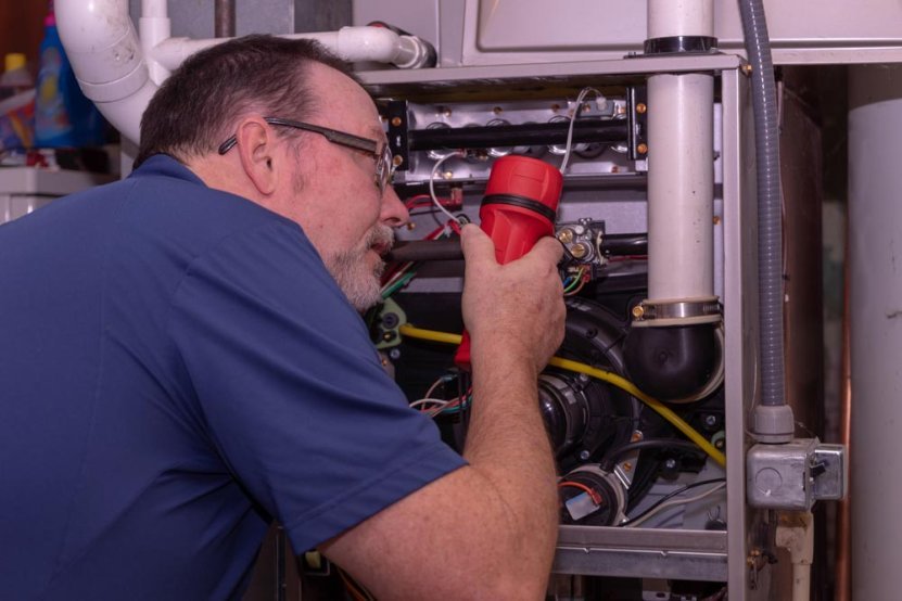 homeowner inspecting a furnace