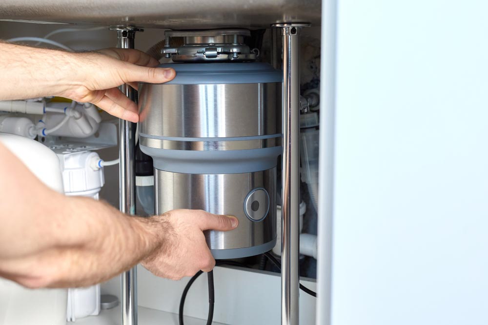 homeowner resetting a garbage disposal
