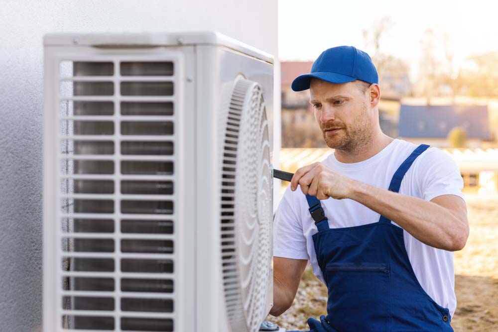 technician installing an HVAC system technician installing an HVAC system