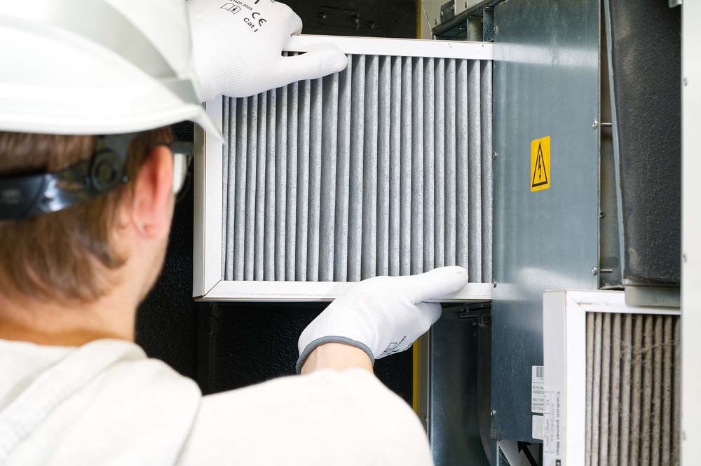 technician changing HVAC filter