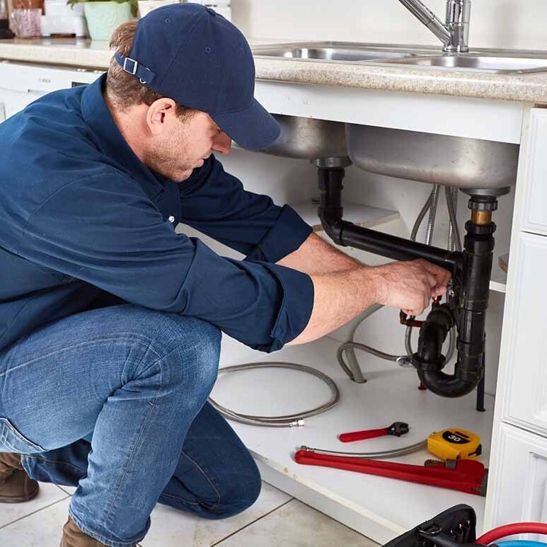 technician-unclogging-a-residential-drain